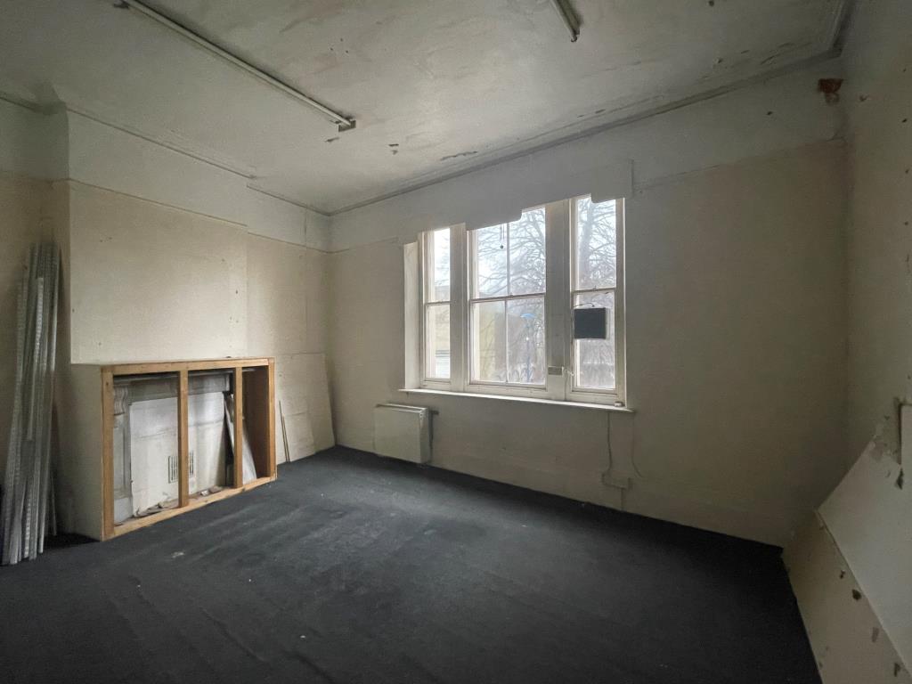 Lot: 45 - TOWN CENTRE PROPERTY WITH VACANT UPPER PARTS - Empty room with fireplace